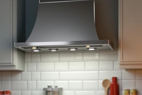 Contemporary stainless steel range hood installed above a stove.